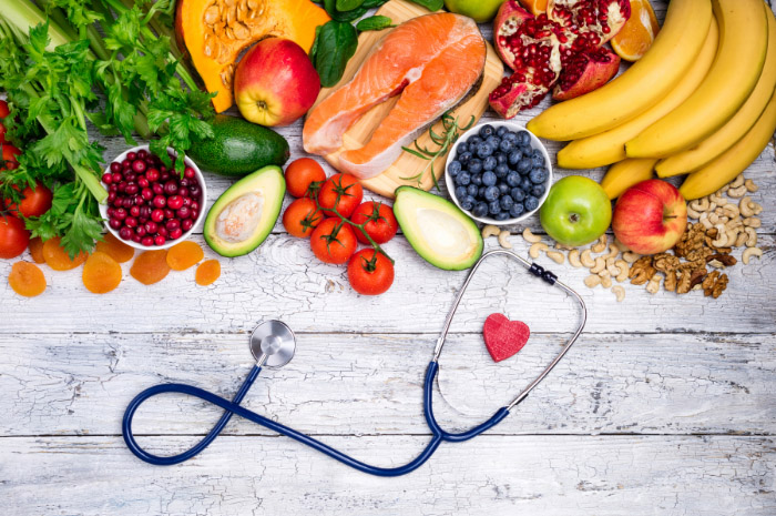 Fresh fruit and vegetables with a heart and stethoscope