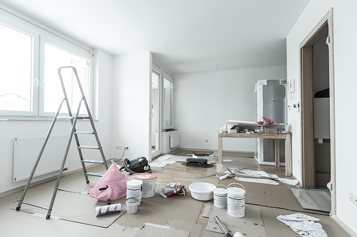 House interior being renovated with ladder and paints on flooring