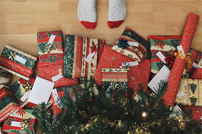 Presents under the Christmas tree and little socks standing nearby