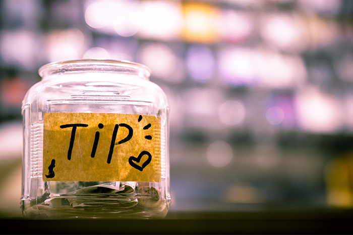 Tip jar with notes and coins