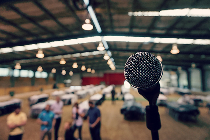 Microphone and stage view of people gathering below