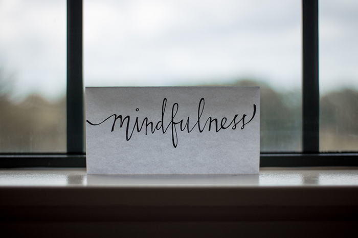 Piece of paper up against window sill reading MINDFULNESS