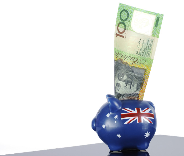 Australian money, one hundred dollar note, in red white and blue piggy bank with Australian flag