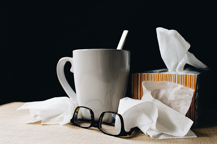 Coffee mug with glasses and tissues