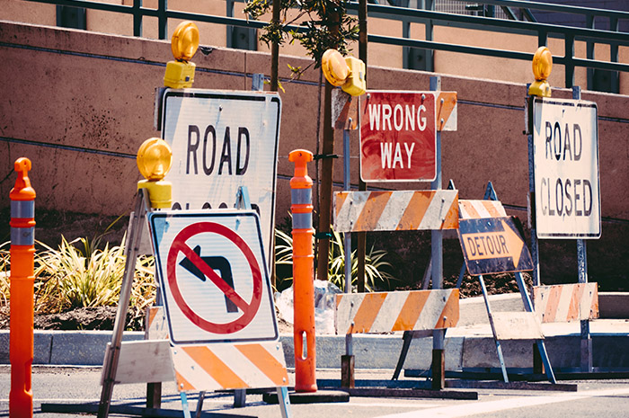 Numerous road signs on street preventing access