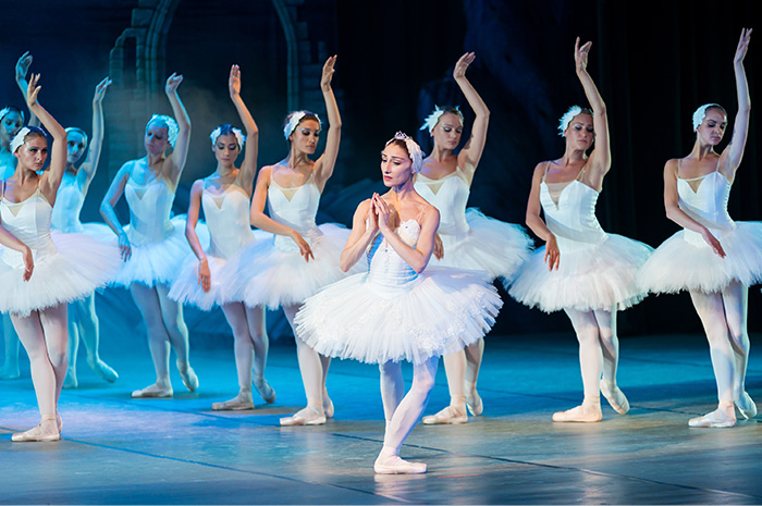 Ballerinas performing on stage in tutus