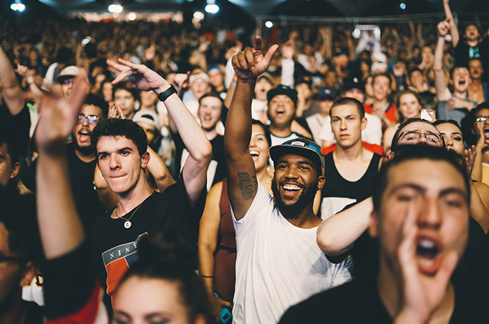 Crowd of young people cheering at concert