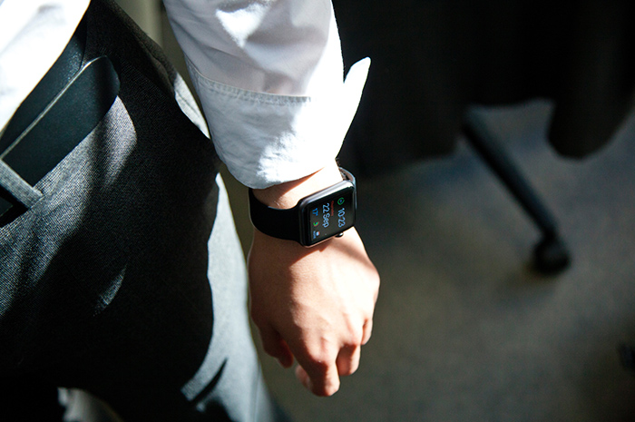 Business man with smart watch tracking fitness and activity