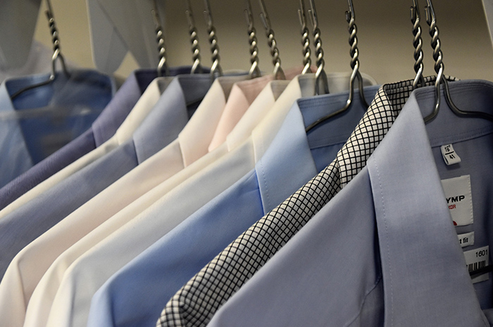 Business shirts hanging in a row on silver coat hangers