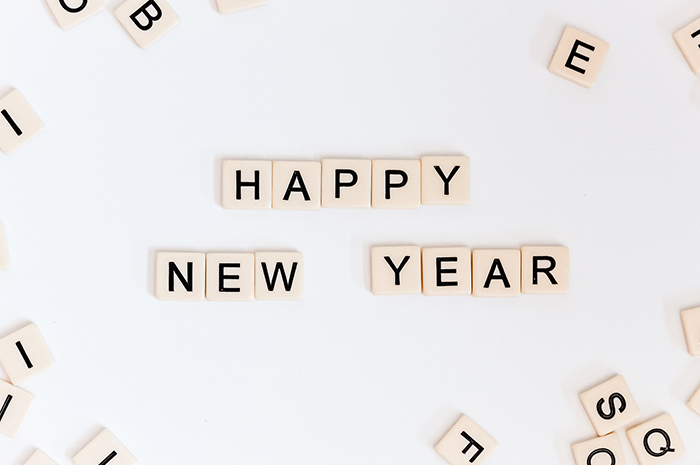 Little letter pieces scattered and put together for wording HAPPY NEW YEAR