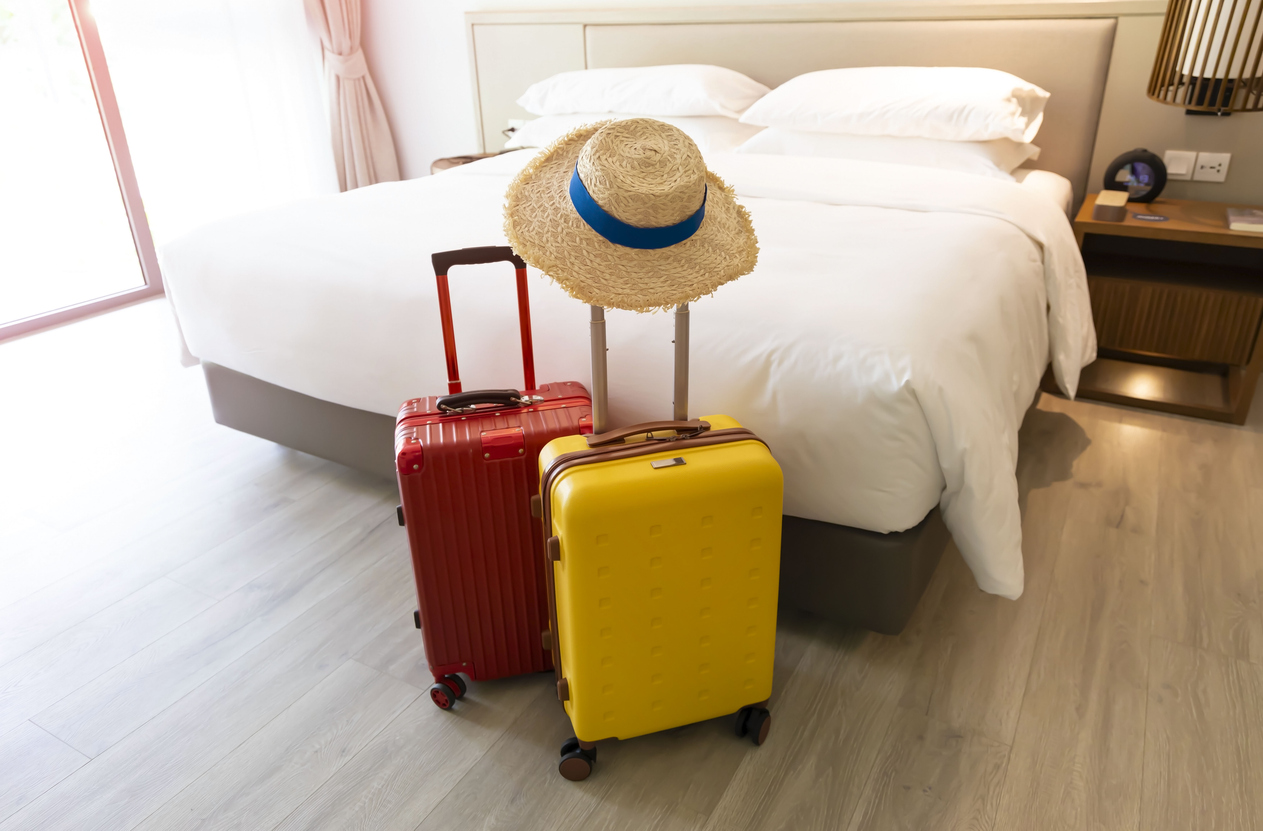 Coloured suitcases in a bedroom Coloured suitcases in a bedroom