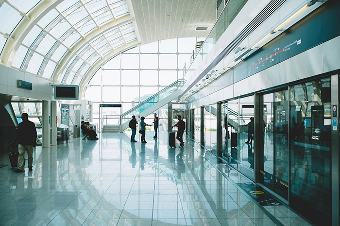 Inside of a busy airport with passengers moving about