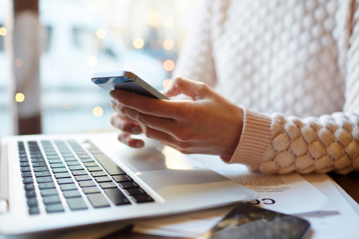 Employee working from home and typing message into phone