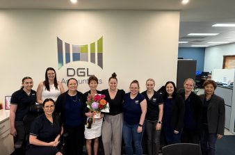 Tax Consultant Colleen surrounded by the DGL Accountants team