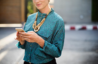 Female holding phone looking at screen
