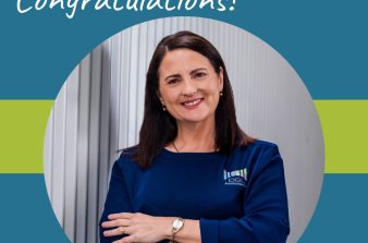 Denise smiling with her arms folded and a "congratulation" text banner