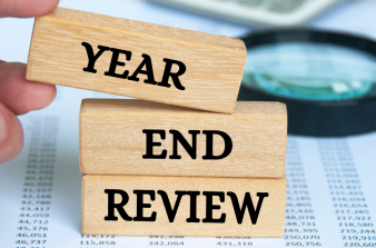 3 wooden blocks with the word Year, End and Review