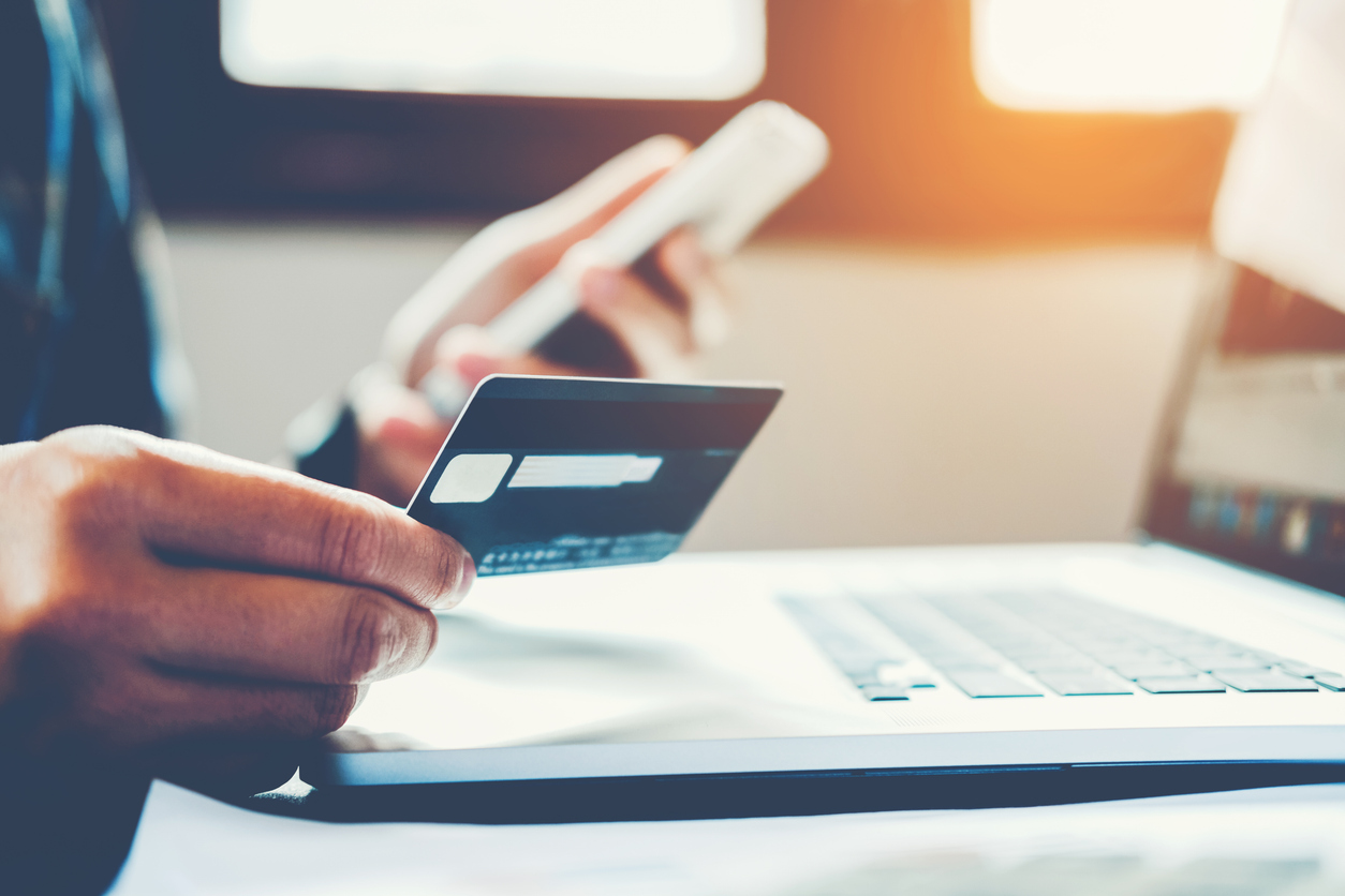 Man Holding Credit Card And Using Cell Phone holding credit card with shopping online Man Holding Credit Card And Using Cell Phone holding credit card with shopping online
